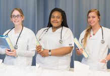 CNA students pose in the CNA Lab on campus in Battle Creek.