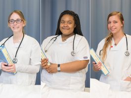 CNA students pose in the CNA Lab on campus in Battle Creek.