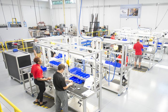 KAMA manufacturing students work on a manufacturing line at the RMTC campus in Battle Creek.