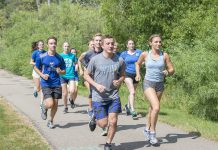 KCC cross-country runners run around Spring Lake.