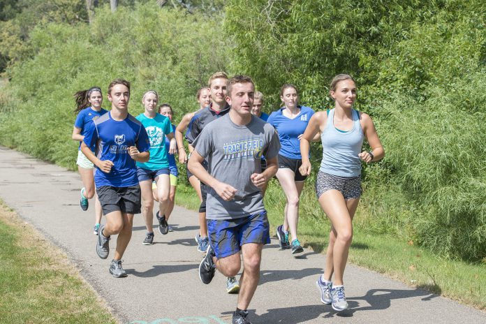 KCC cross-country runners run around Spring Lake.