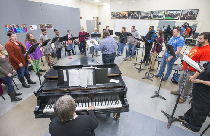 KCC choir members rehearse in the choir room.