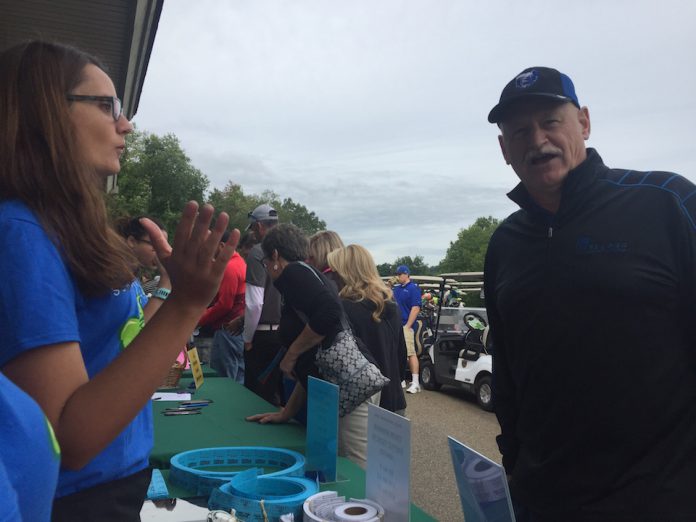 Two KCC employees work the tables at the KCC Bruin Open.