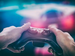 Multimedia image of someone holding a game controller