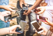 Image of people holding smartphones in a circle.