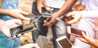 Image of people holding smartphones in a circle.