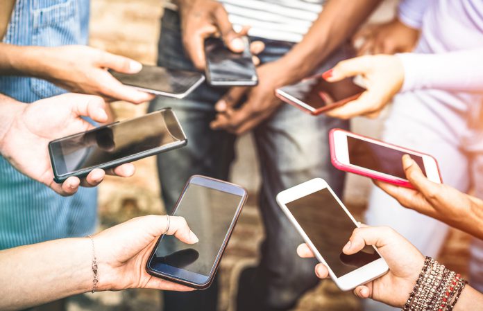 Image of people holding smartphones in a circle.