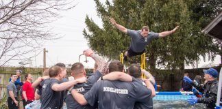 KCC Police Academy cadets cheer on a fellow student as he jumps during the polar plunge event in 2017.