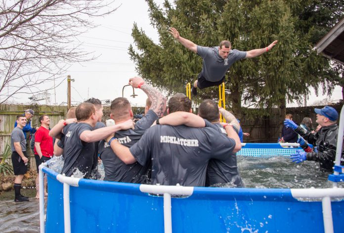 KCC Police Academy cadets cheer on a fellow student as he jumps during the polar plunge event in 2017.