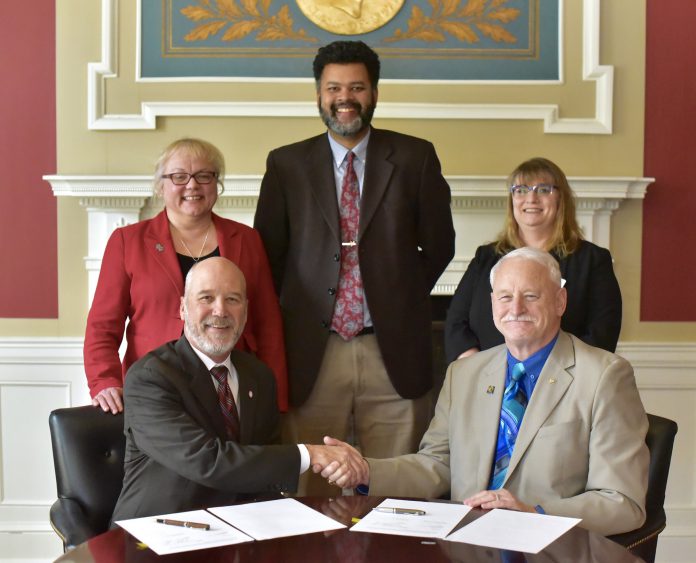 KCC's Vice President and President sitting with deans and instructors from Olivet College