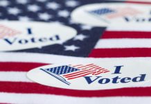 "I Voted" stickers on an American flag.