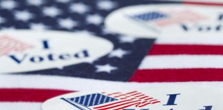 "I Voted" stickers on an American flag.