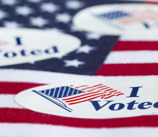 "I Voted" stickers on an American flag.