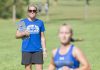 Head KCC Cross-Country Coach Erin Lane watches a runner finish at the Knight-Raider Invitational in Grand Rapids in 2019.