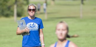 Head KCC Cross-Country Coach Erin Lane watches a runner finish at the Knight-Raider Invitational in Grand Rapids in 2019.