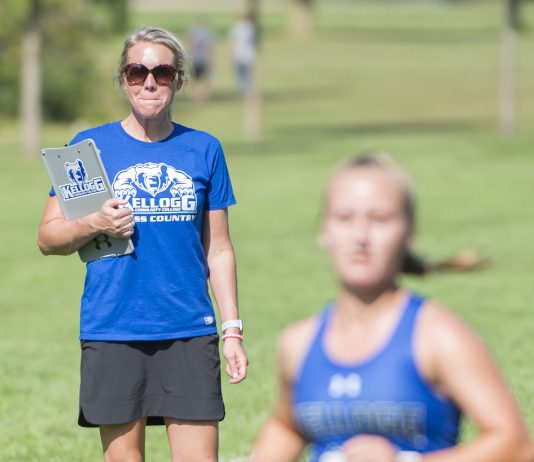 Head KCC Cross-Country Coach Erin Lane watches a runner finish at the Knight-Raider Invitational in Grand Rapids in 2019.