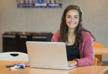 A student works on a laptop in the Student Center.