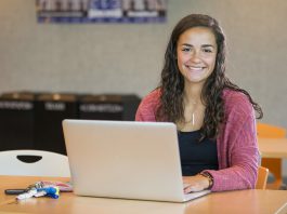 A student works on a laptop in the Student Center.