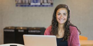 A student works on a laptop in the Student Center.