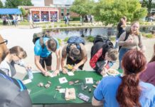 Students sign up for clubs at a table on KCCs campus during the Bruin Blast event