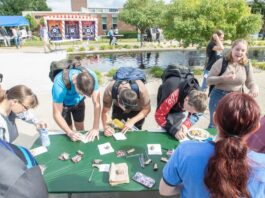 Students sign up for clubs at a table on KCCs campus during the Bruin Blast event