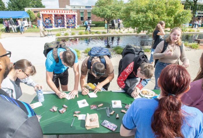 Students sign up for clubs at a table on KCCs campus during the Bruin Blast event