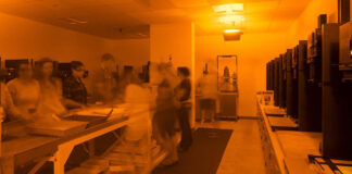 A view of the Kellogg Community College darkroom under red safelights.