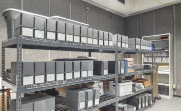 Boxes stacked on shelves in the KCC archives.