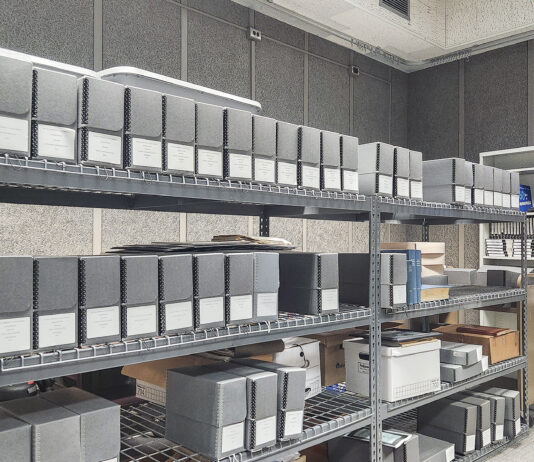 Boxes stacked on shelves in the KCC archives.