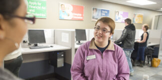 A student worker assists a visitor to the Hub.