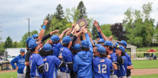 KCC baseball players celebrate after winning the regional championship. Photo by Allie Dietzel.